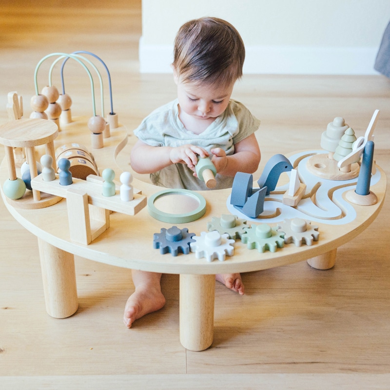 A Toddler playing with Infant and Toddler Activity Table