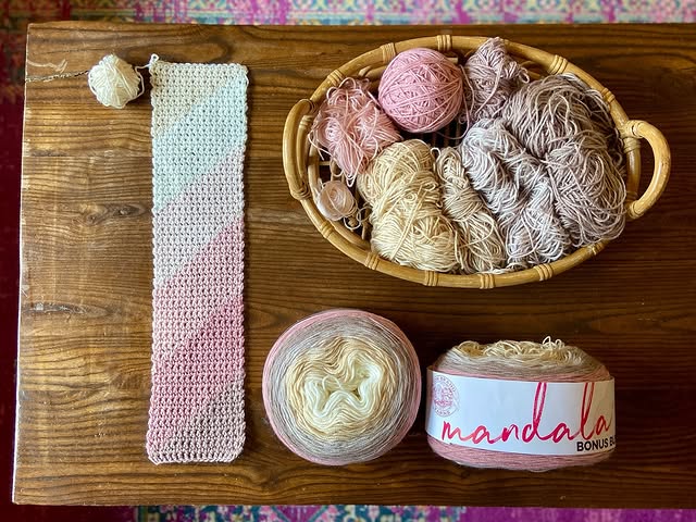 Lion Brand Yarn Mandala Yarn placed on a wooden surface