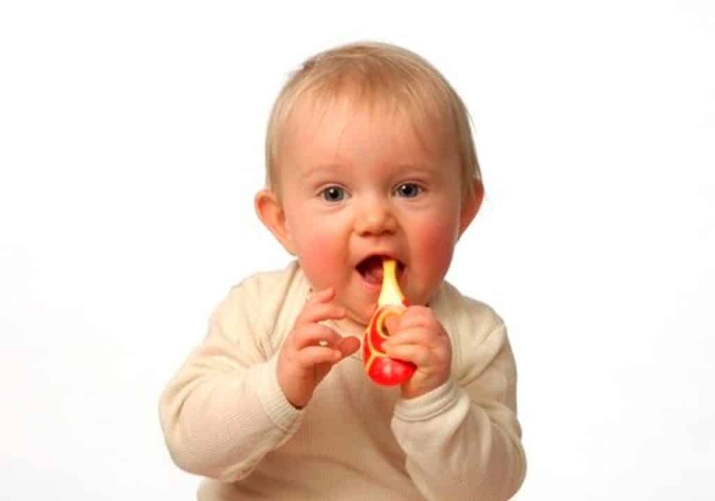 baby holding Jordan Step Baby Toothbrush