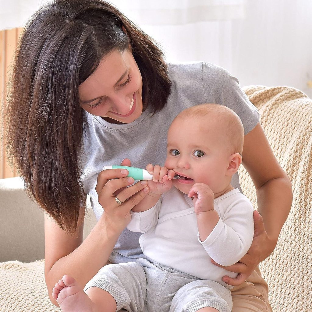 mom trying to help baby clean teeth using BabySonic Infant and Toddler Electric Toothbrush​
