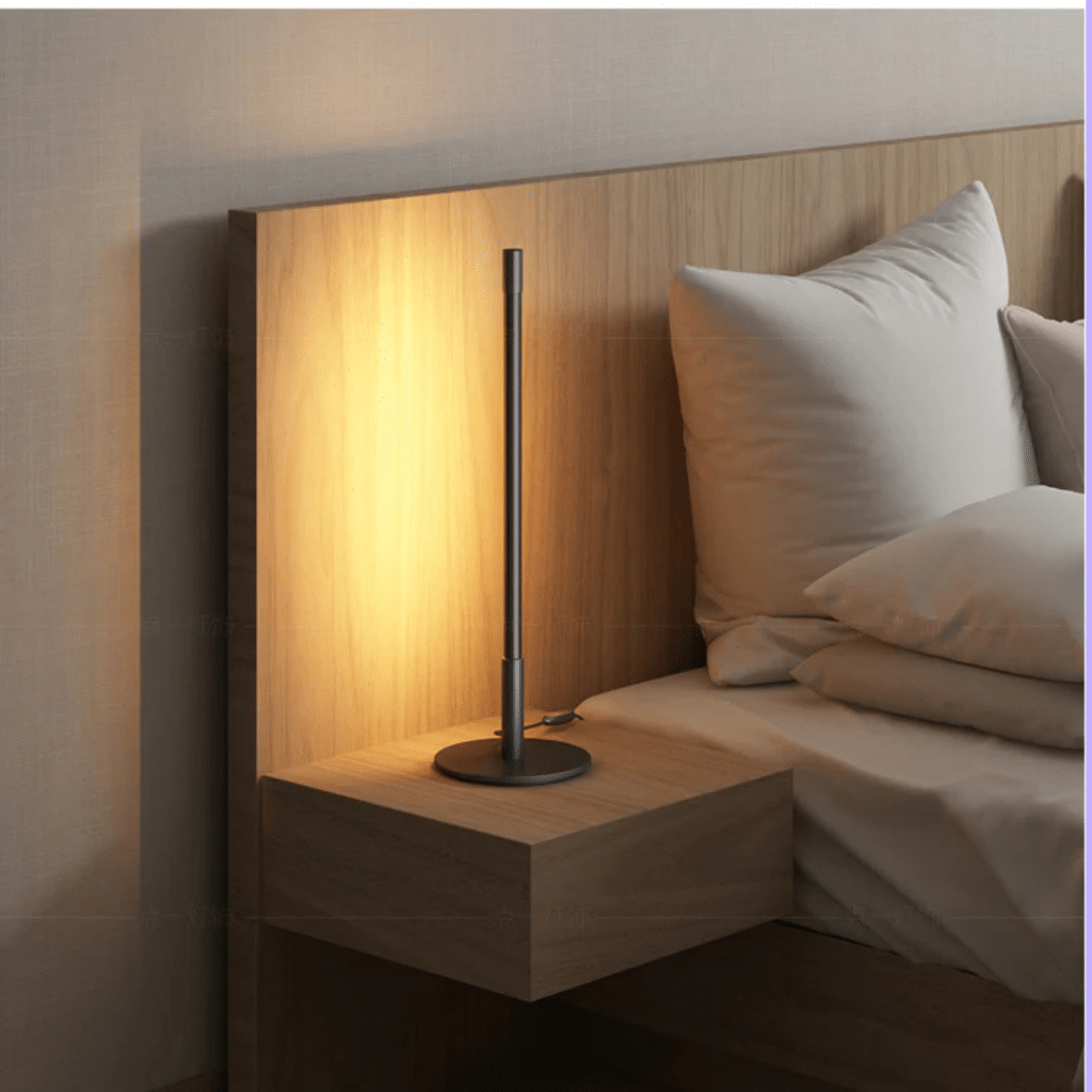 A view of a desk lamp by the bedside