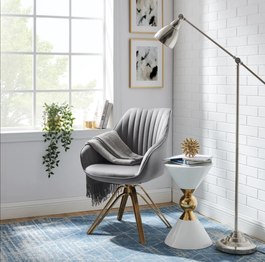 A view of a grey accent chair in a corner