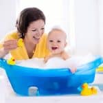 Happy Baby Taking A Bath Playing With Foam Bubbles Mother