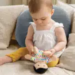 baby playing with a doll