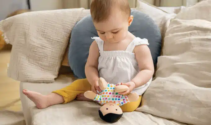 baby playing with a doll