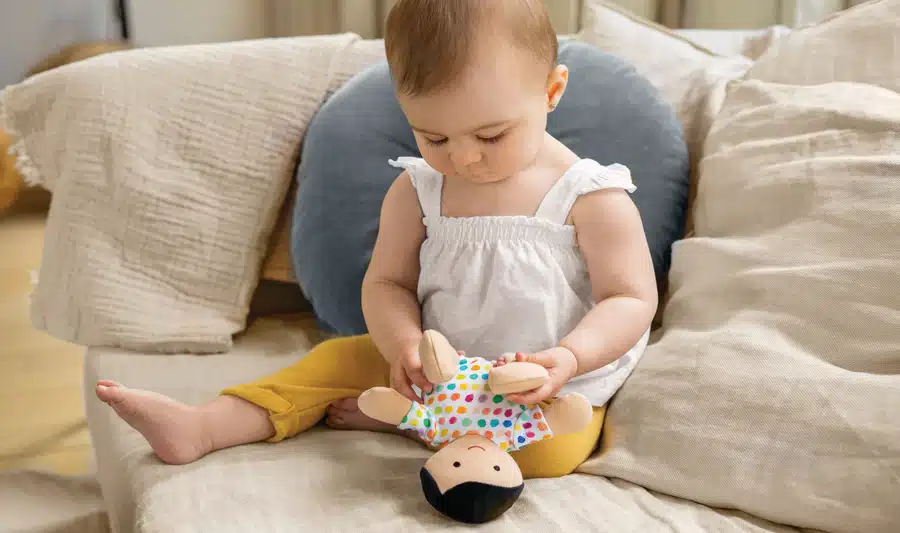 baby playing with a doll