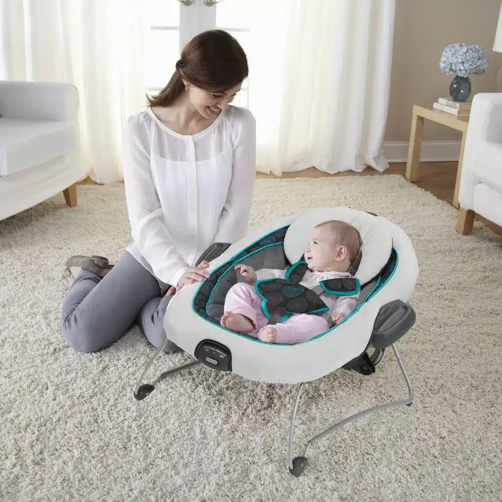 mom with baby playing in Graco DuetConnect LX Seat Bouncer​