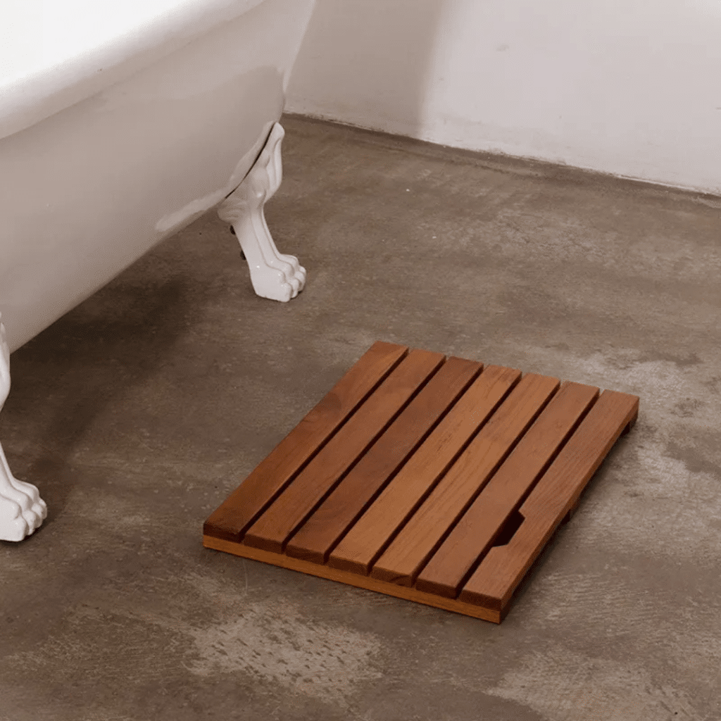 A view of a teak bathmat inside a bathroom