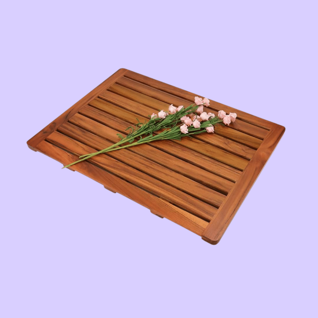 A view of the Utoplike Teak Wood Bath Mat with a flower on top