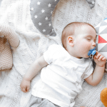 Cute sleeping baby boy with pacifier in his mouth