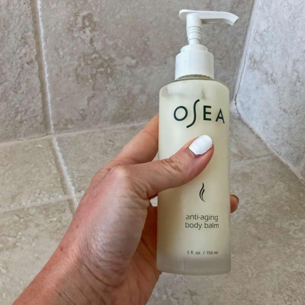 A view of a hand holding an anti age body lotion