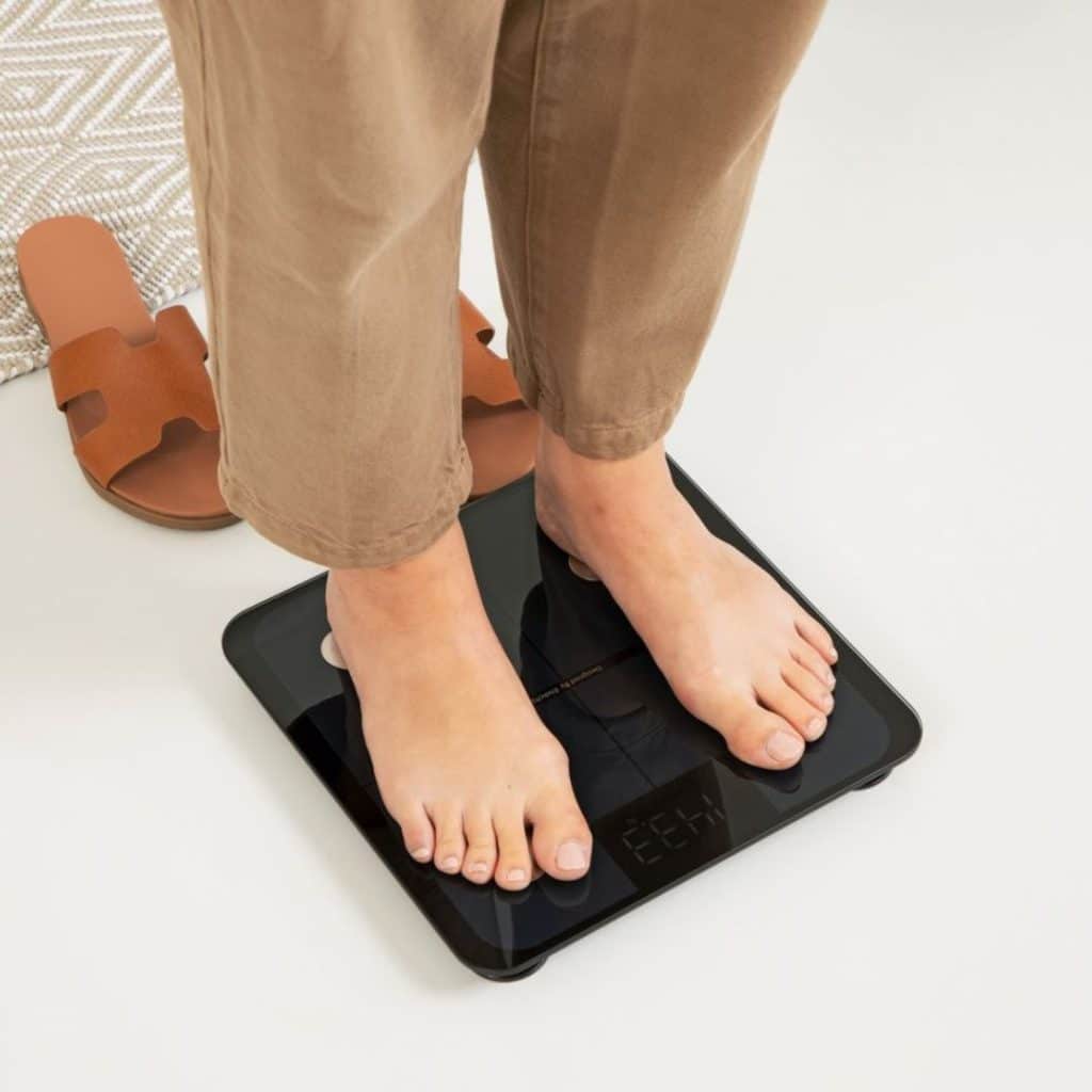 A view of a person standing on a bath scale