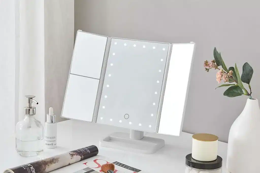 A view of a trifold mirror on a makeup dressing table