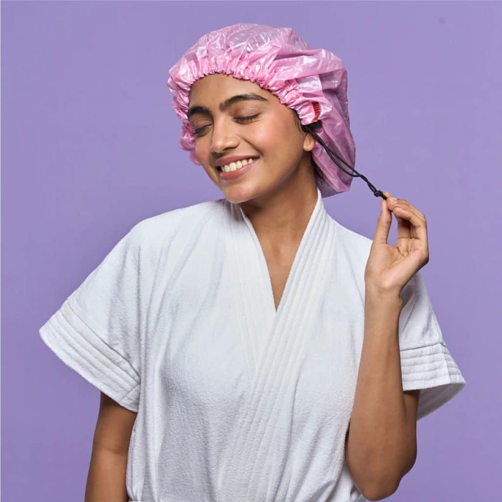 A view of a woman wearing a shower cap