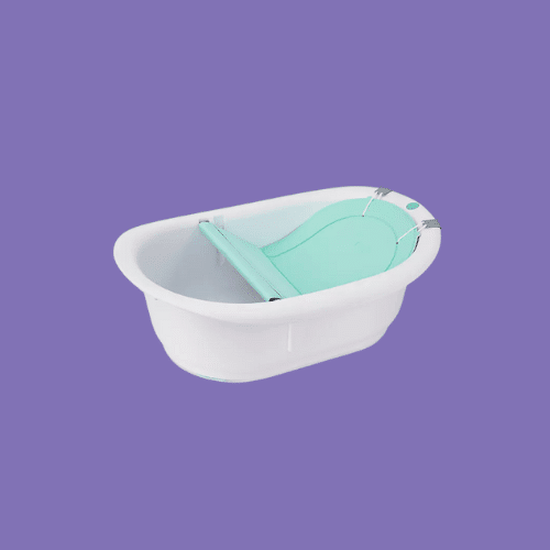 Frida Baby in Grow with Me Baby Bathtub isolated on a purple background