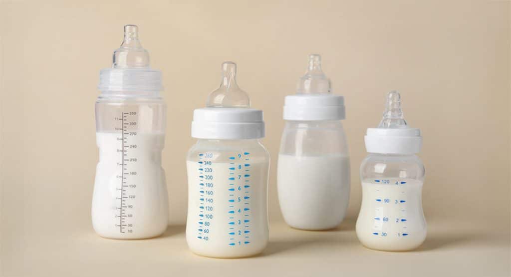 different baby bottles placed on surface
