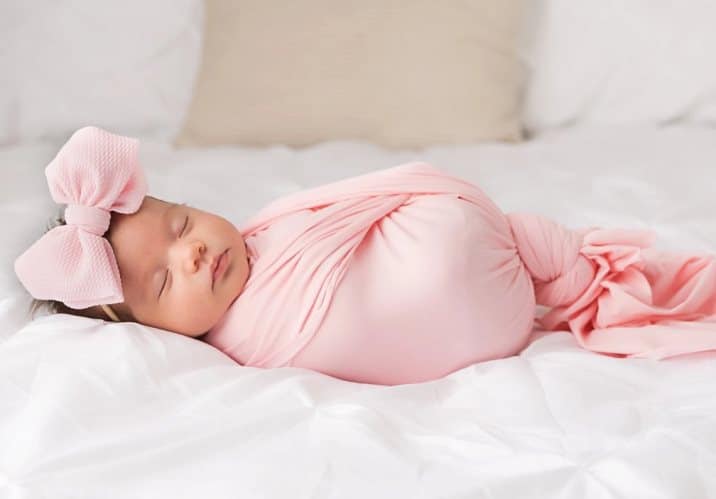 baby girl sleeping in a baby swaddle