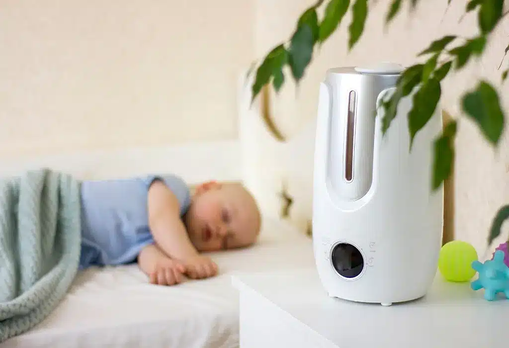 humdifier placed on side table baby sleeping in background