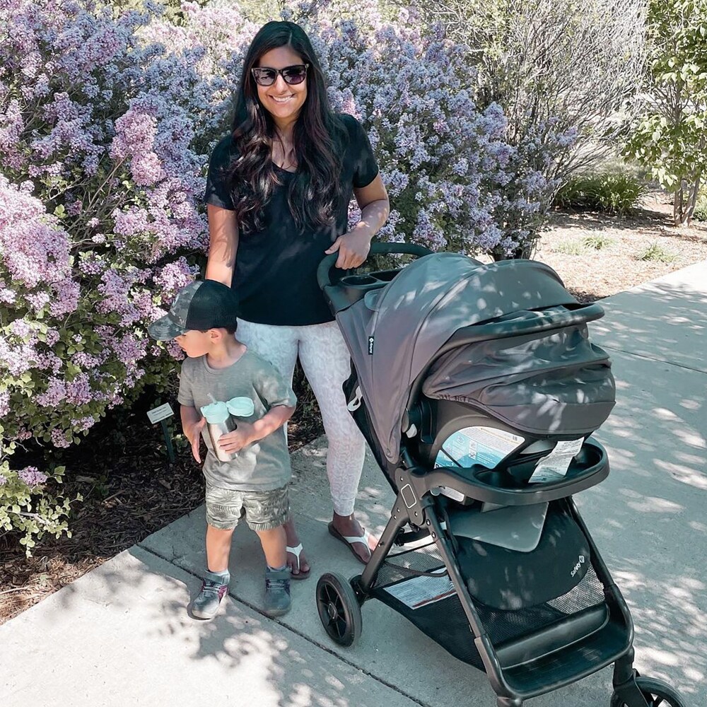 Mom with her kid holding Safety 1st Smooth Ride Travel System Stroller