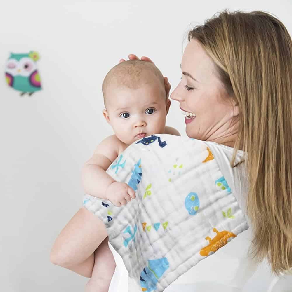 a mom holding a baby Maliton Muslin Baby Burp Cloth on her shoulder