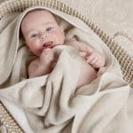 cute baby wrapped in a soft cozy hooded towel