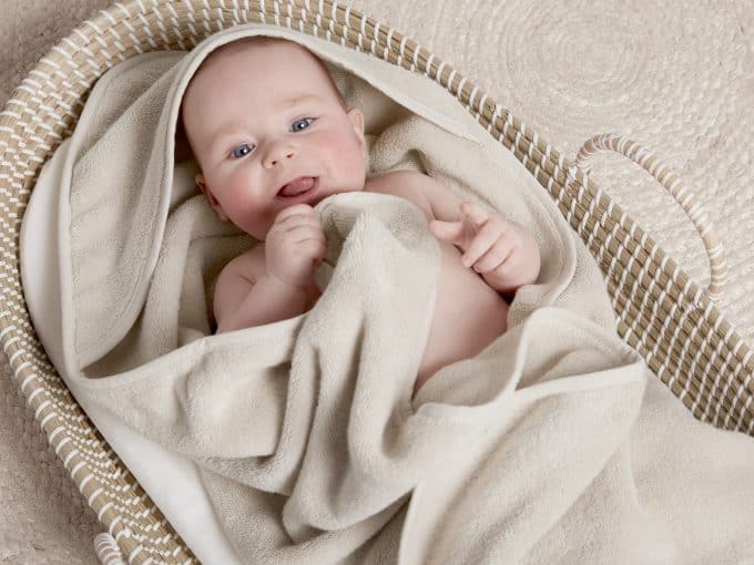 cute baby wrapped in a soft cozy hooded towel