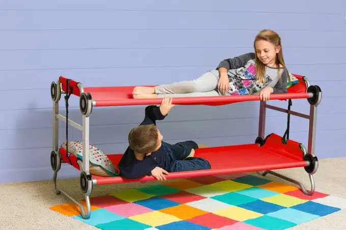 kids playing in a double toddler cot