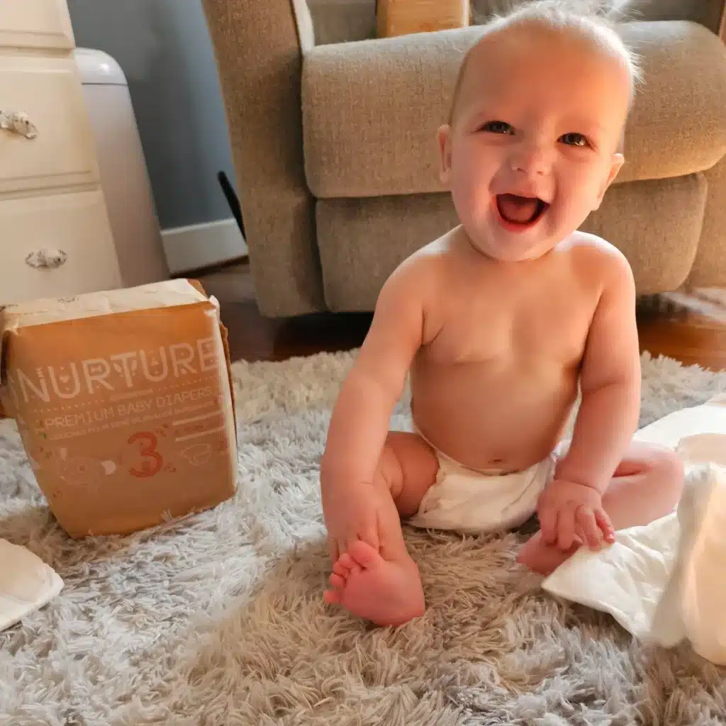 a baby giggling and wearing Nurture Diapers by BioBag