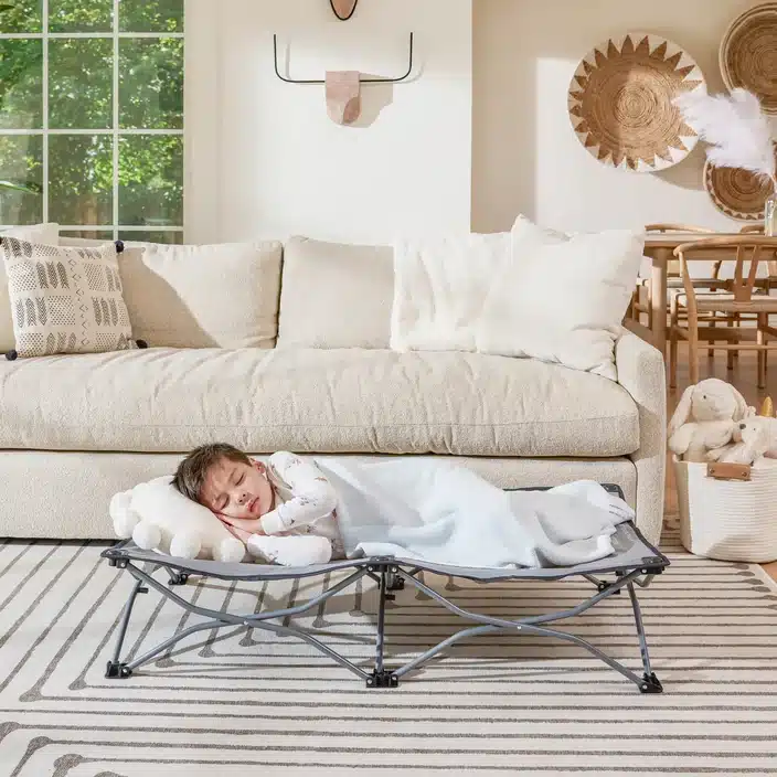 a baby sleeping on Regalo My Cot Deluxe Portable Toddler Bed