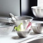 colander and bowls placed on a counter