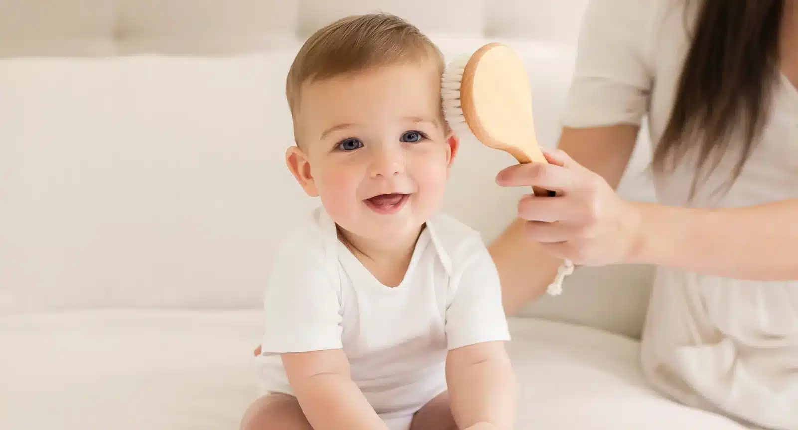 mom brushing baby hair with a brush