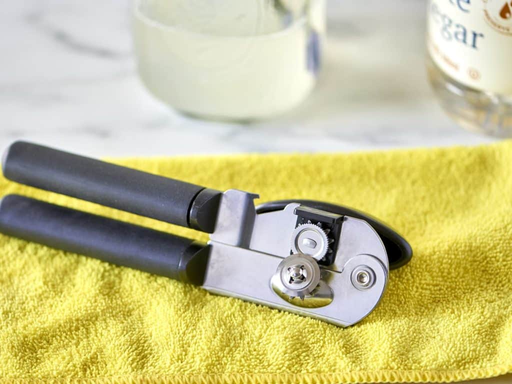 A view of a can opener on a yellow cloth