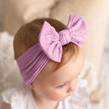 a Baby wearing lilac color Headband
