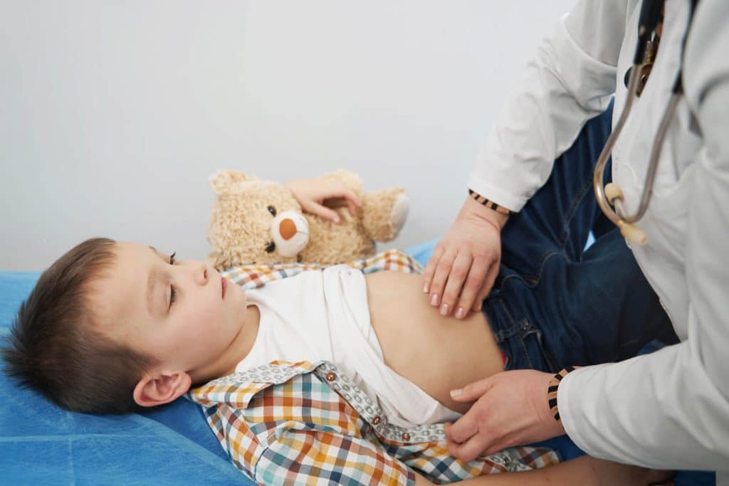 a doctor massaging baby s tummy