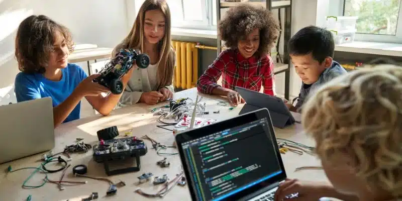 a group of kids using technology and learning