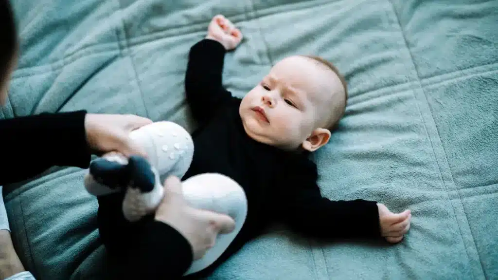 close up of mom s hands massaging a baby to treat stomach ache