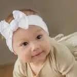 cute baby wearing white headband