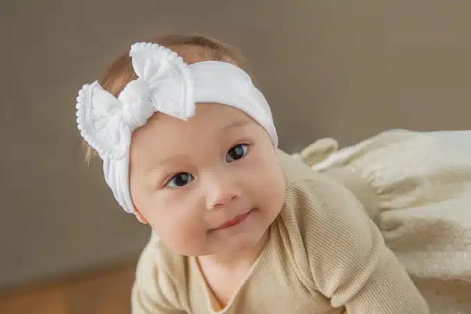 cute baby wearing white headband