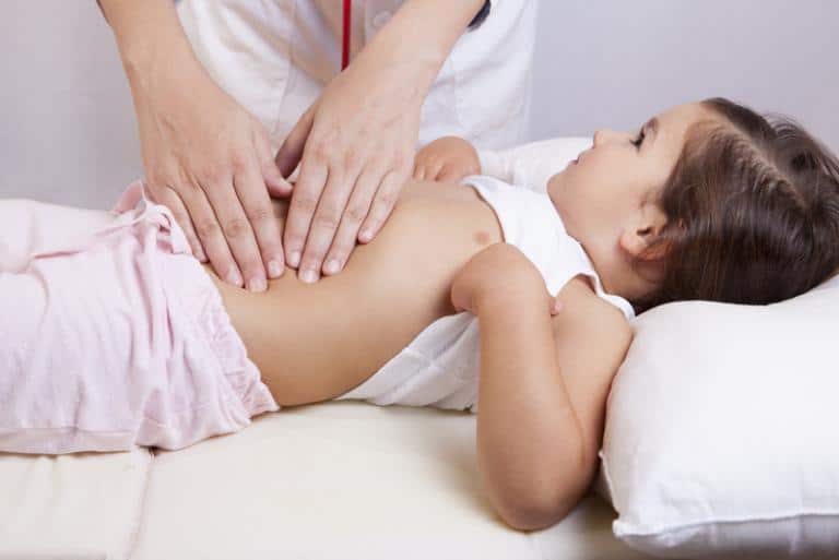 zoomed view of a pediatrician checking a baby s tummy