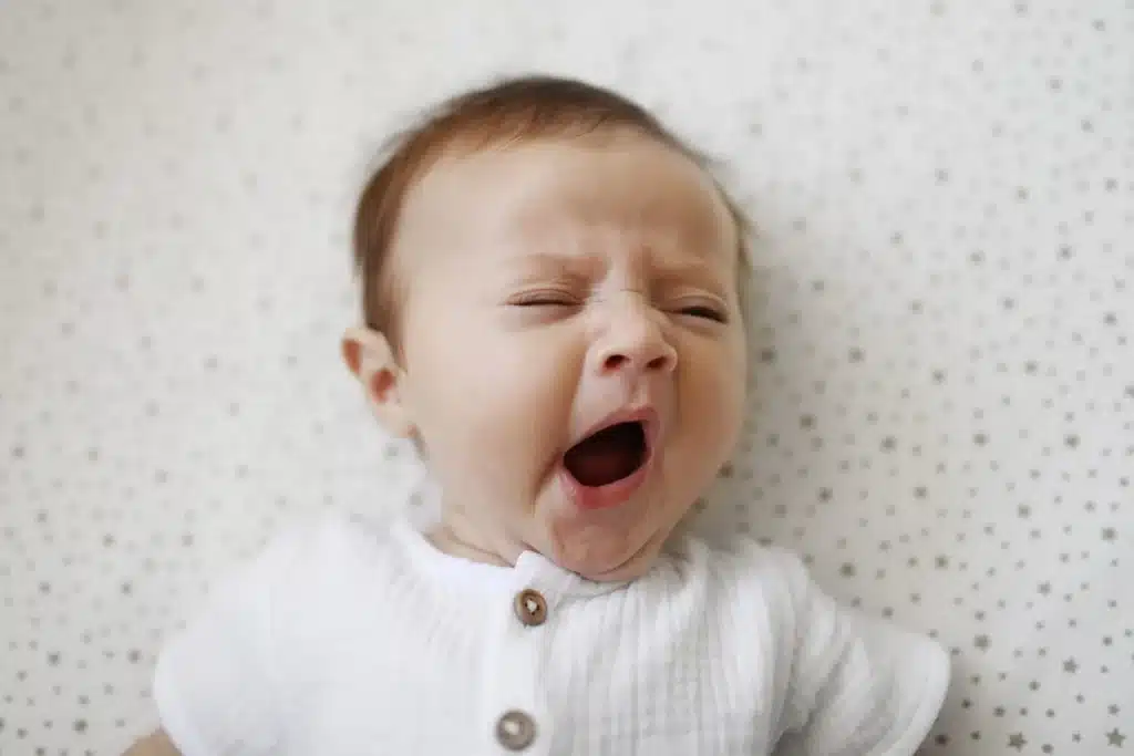 A cute baby yawning and about to sleep
