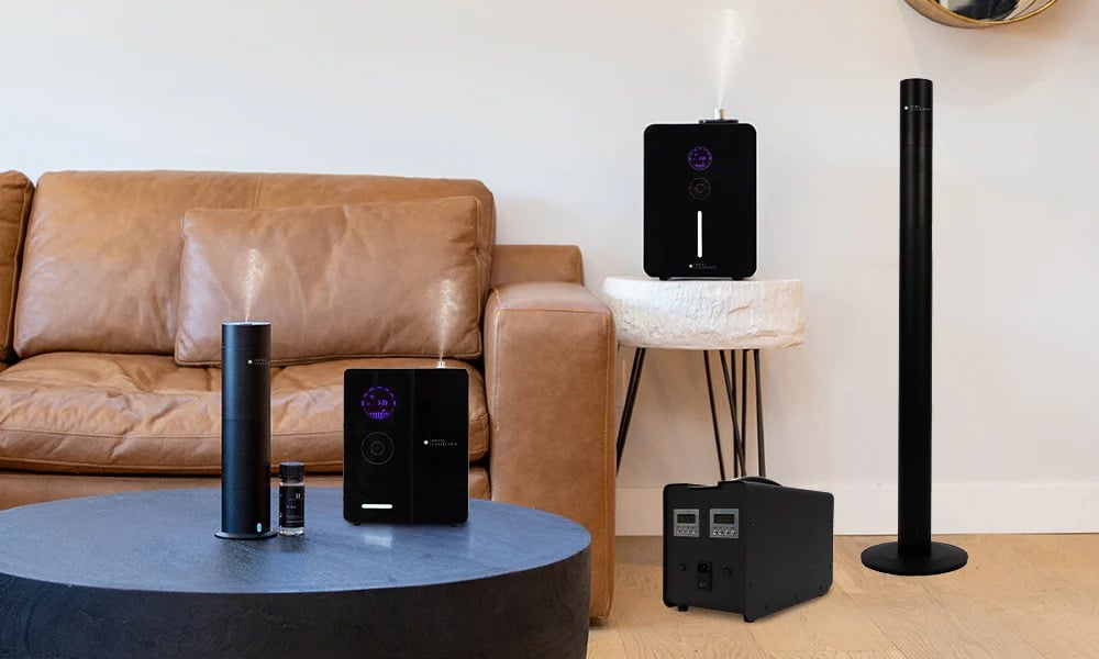 A modern living room with a black air purifier essential oil diffuser and a second air purifier in the background zon