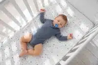 a baby peacefully sleeping in a crib