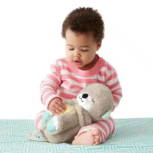 a baby playing fisher soother and snuggler