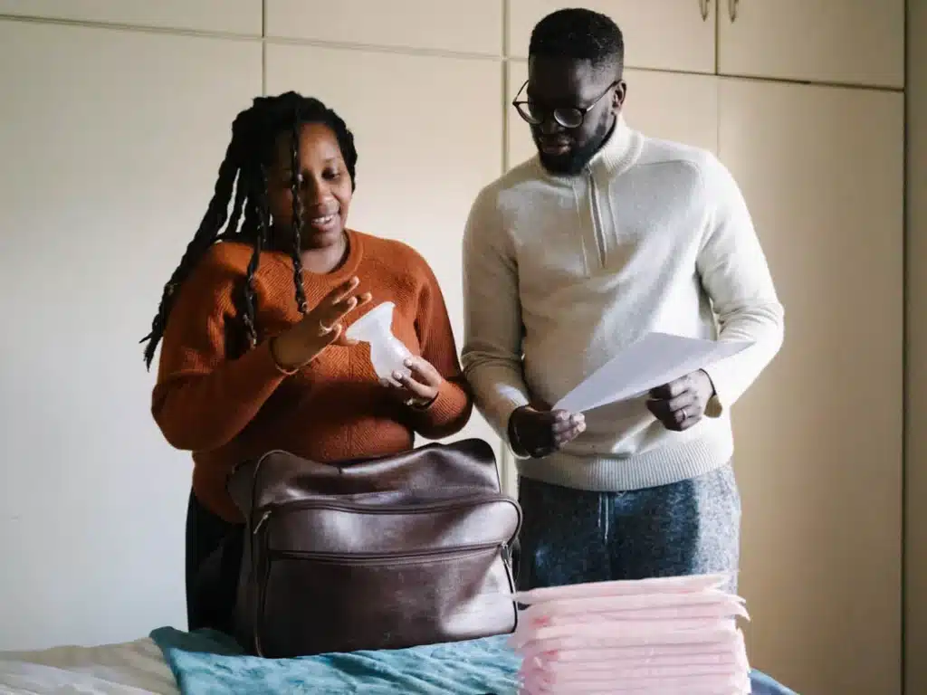 a couple packing hospital bag