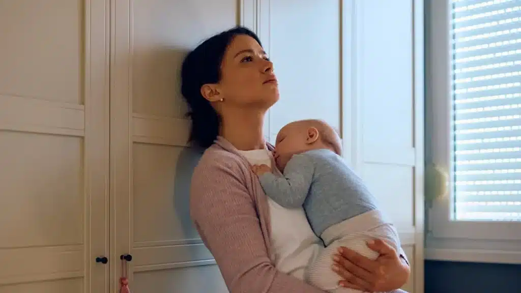 a depressed mom holding her baby