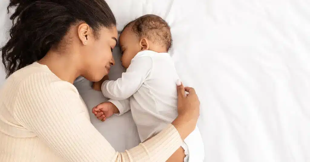 a mother and a new born baby sleeping peacefully