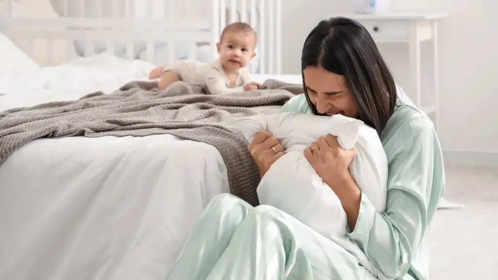 a new mom seems to be utterly sad and depressed her baby on the bed