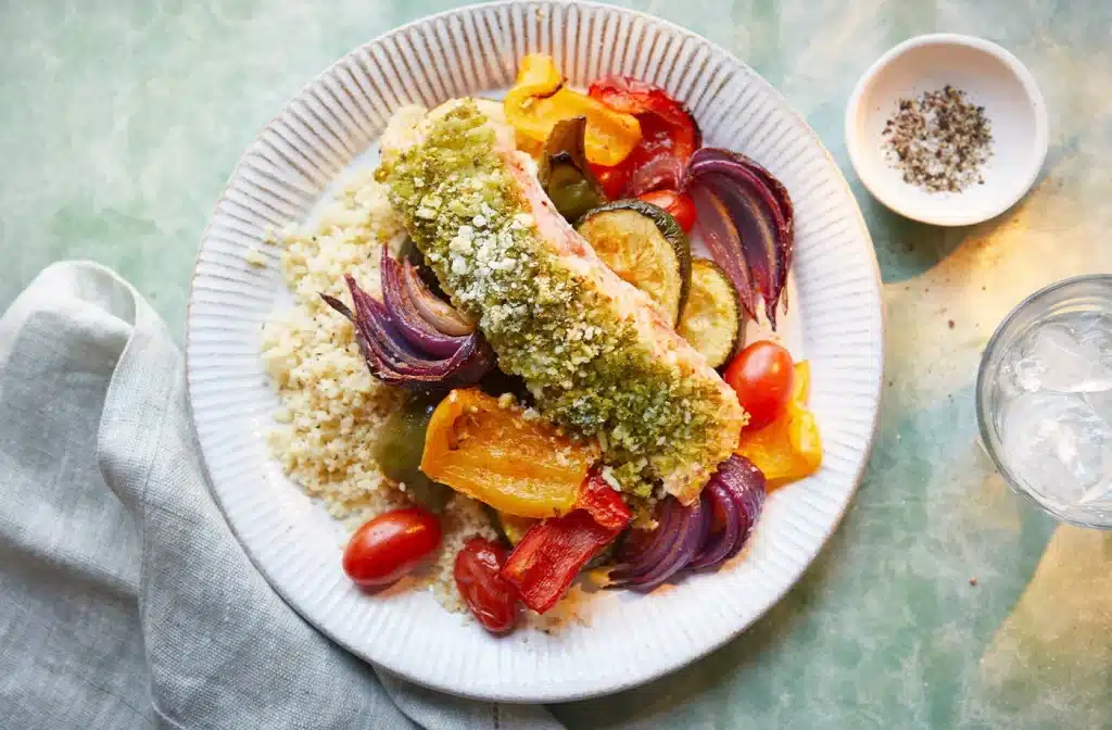 a plate with crusted salmon and roasted veggies