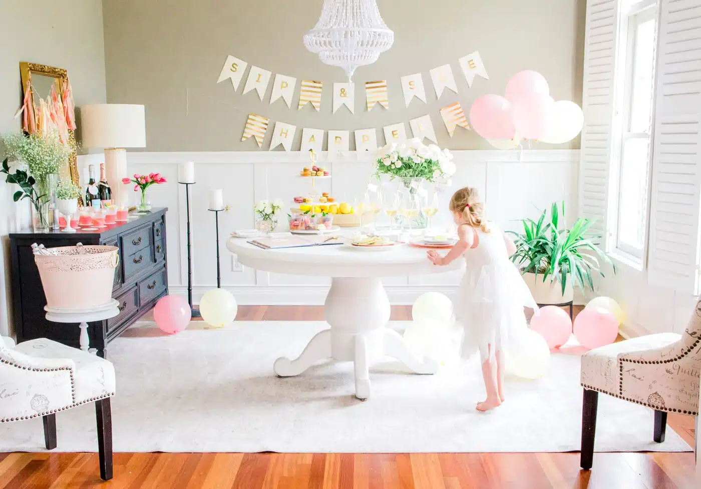 minimal pink and white decor for sip and see party